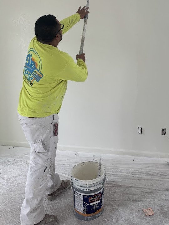 Anaya's Painting crew member rolling a freshly painted wall