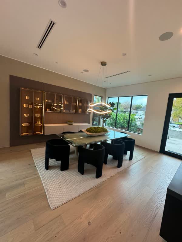 Open living and dining room repainted in a Beverly Hills home